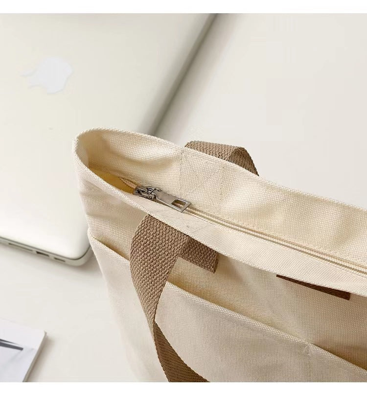 Cream canvas carryall tote with double shoulder straps